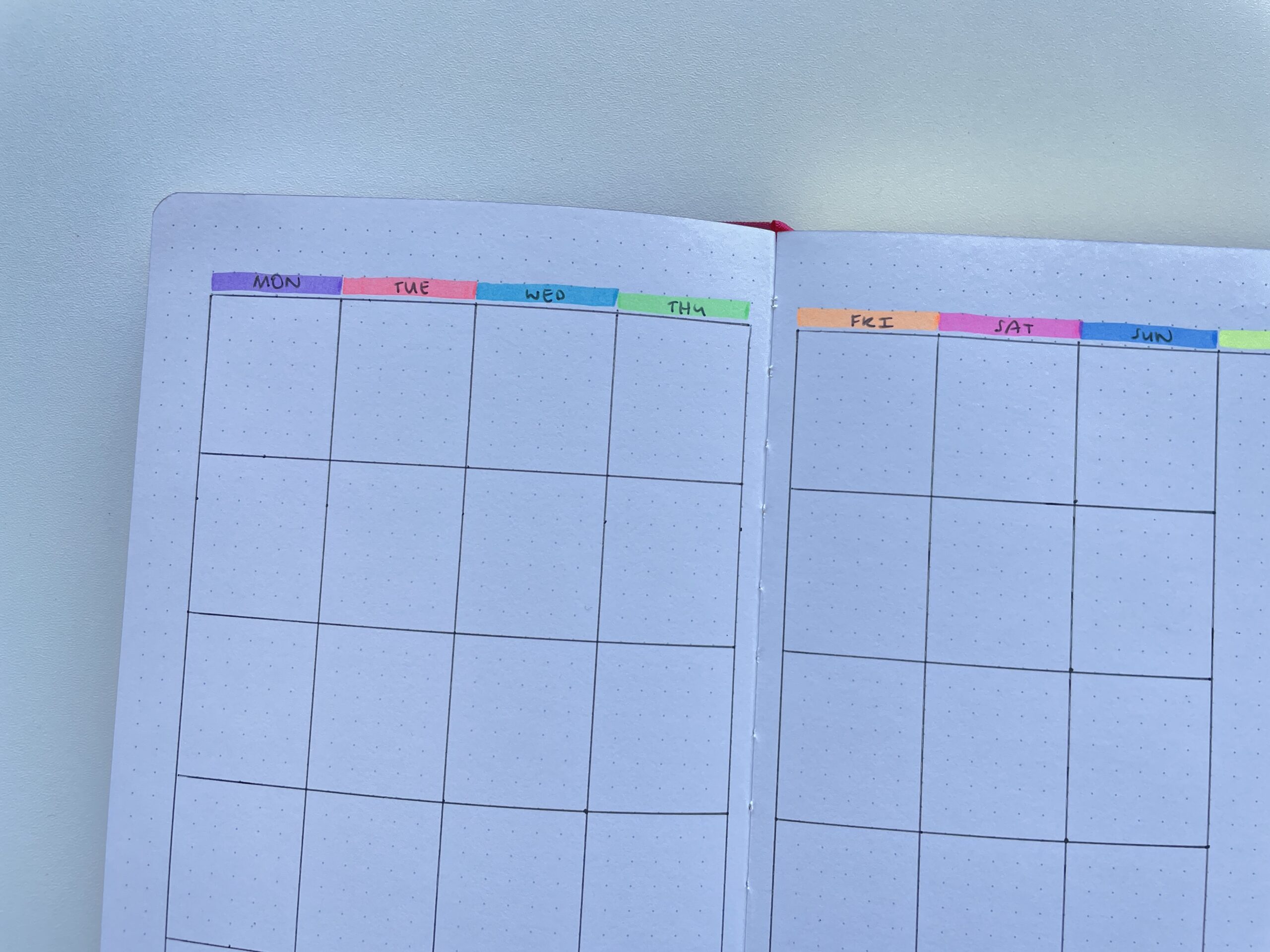 rainbow minimalist bullet journal weekly spread bujo layout what size are the boxes for each day in an 5 notebooks